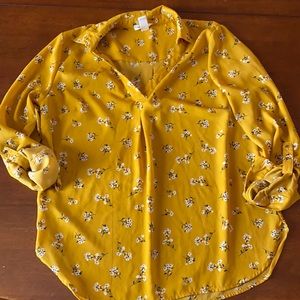 Blouse yellow with white flower details.